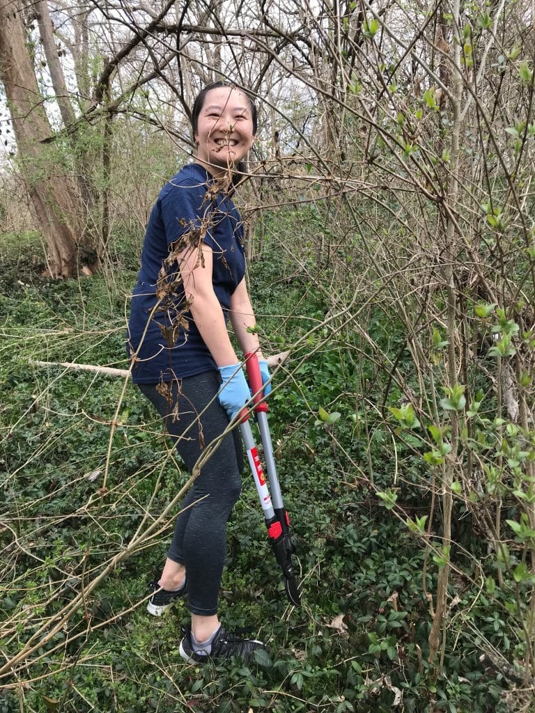 Jenny Zhang participating in Weed Wrangle 2022 at The Land Trust for Tennessee's Glen Leven Farm.